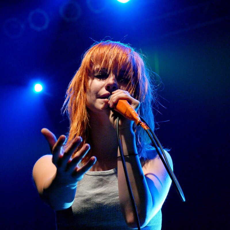 woman singing on stage