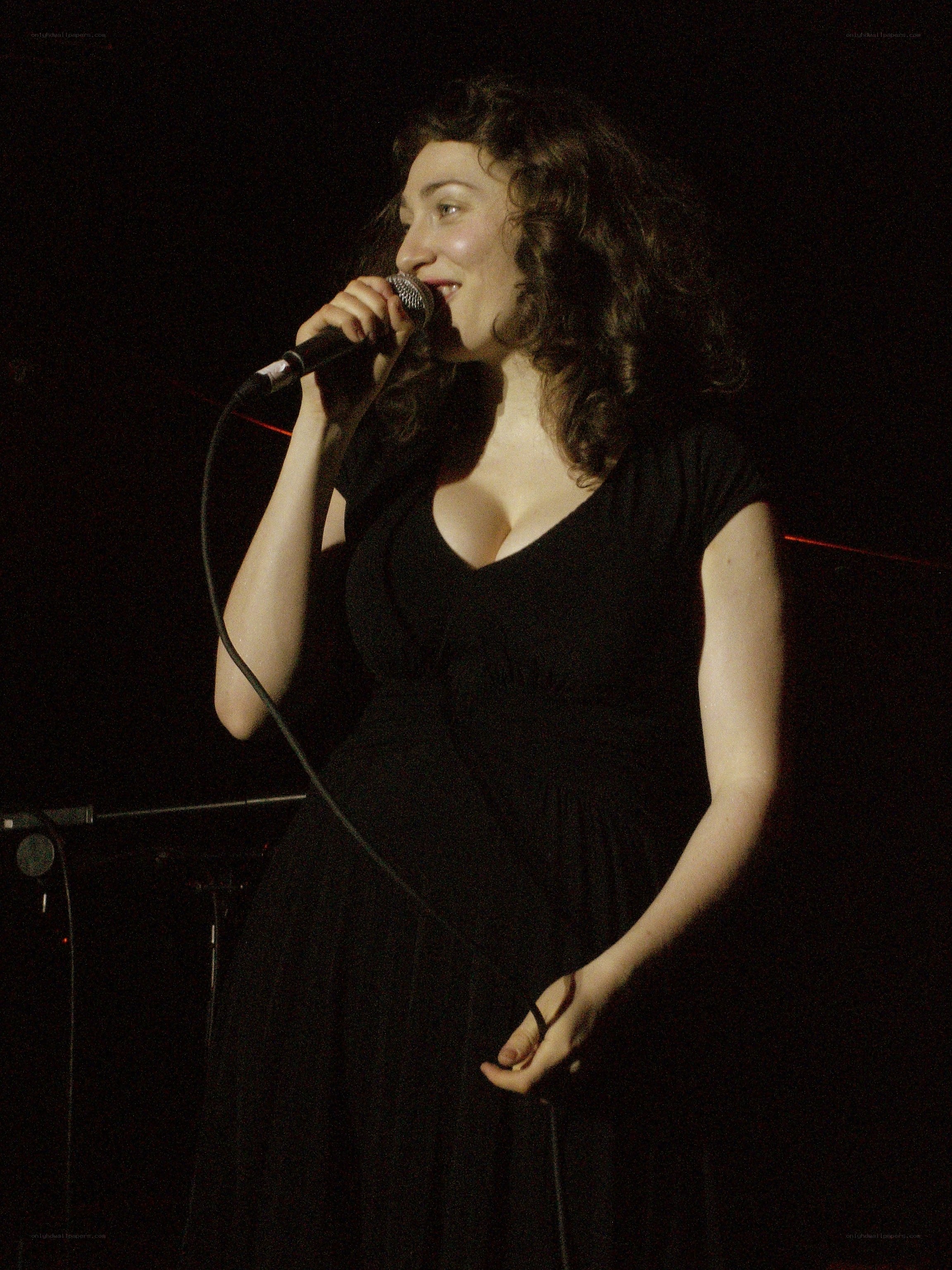 woman singing on stage