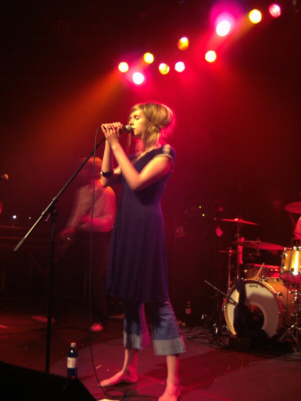 woman singing on stage