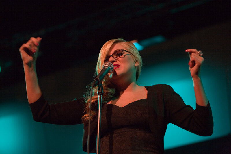 woman singing on stage
