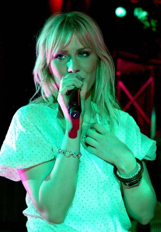 woman singing on stage
