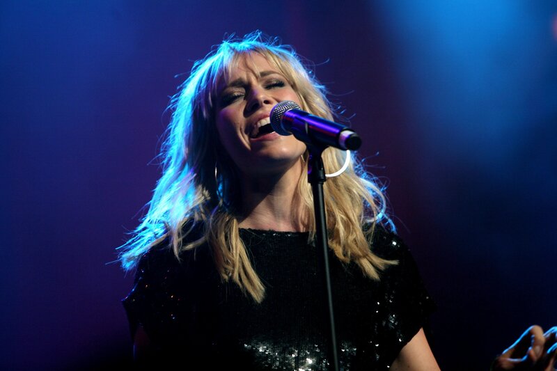 woman singing on stage