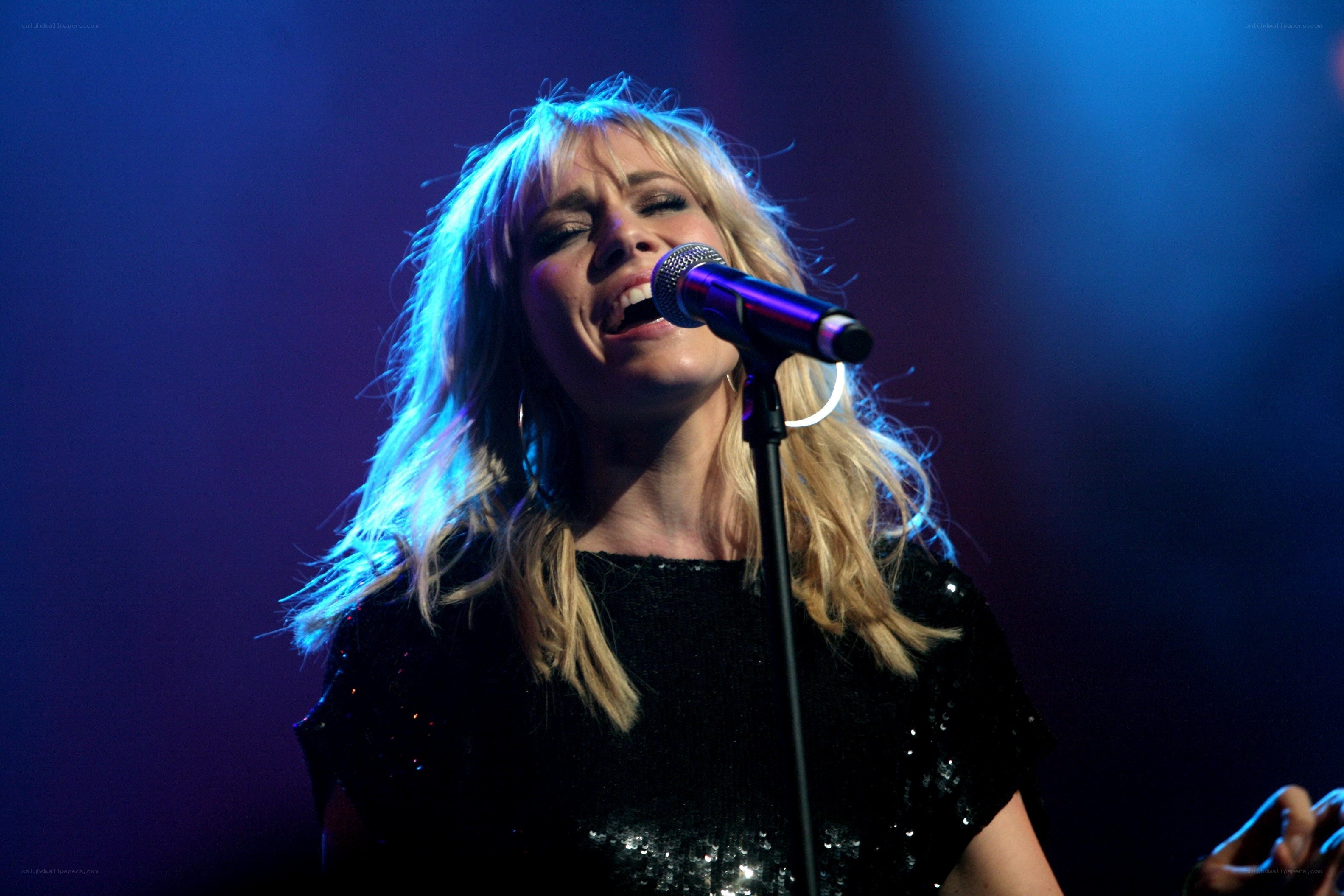 woman singing on stage
