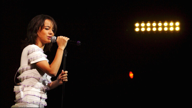 woman singing on stage