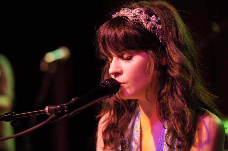 woman singing on stage
