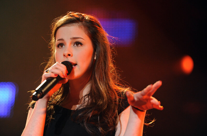 woman singing on stage