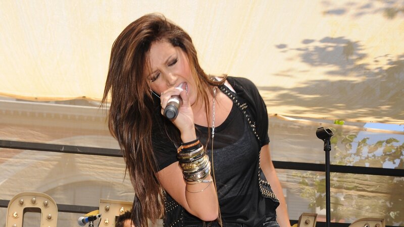 woman singing on stage