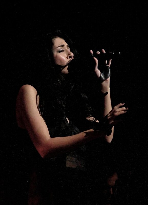 woman singing on stage