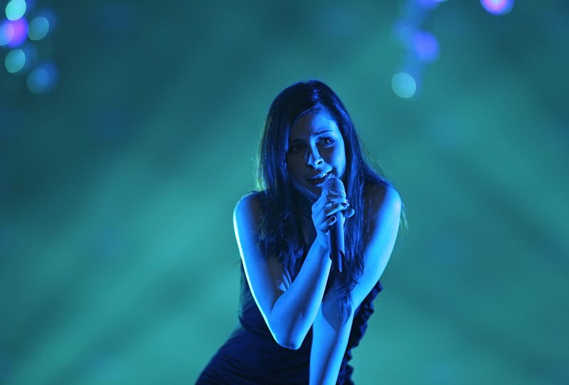 woman singing on stage