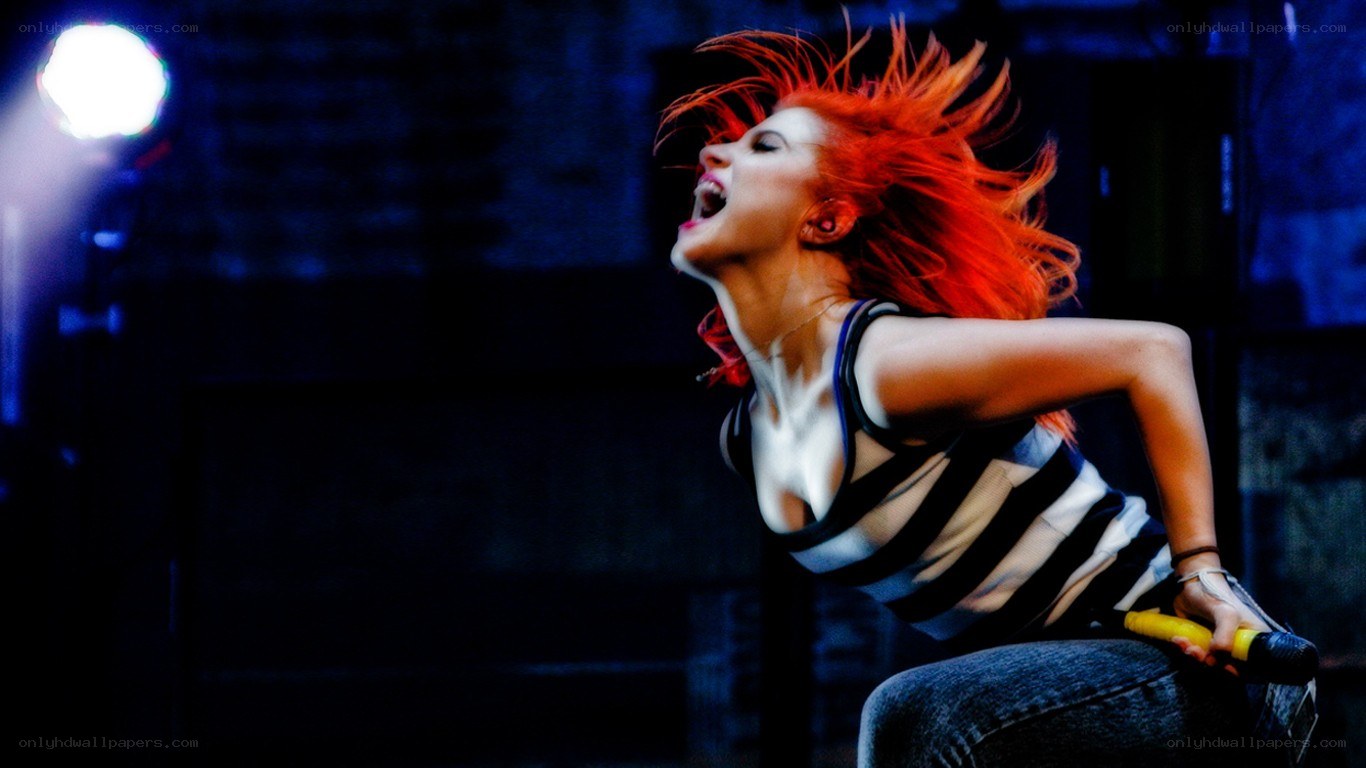 woman singing on stage