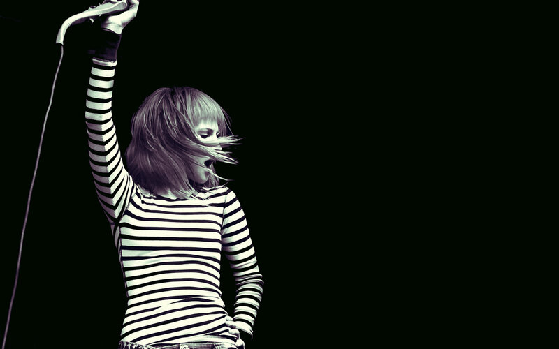 woman singing on stage
