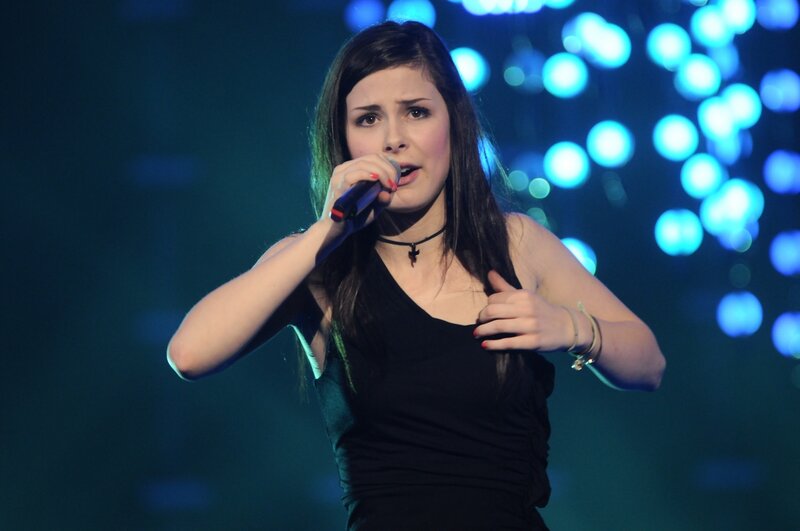 woman singing on stage