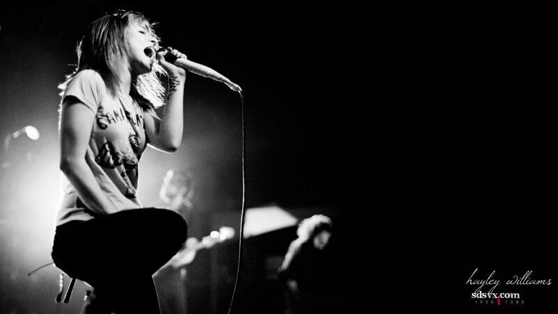 woman singing on stage