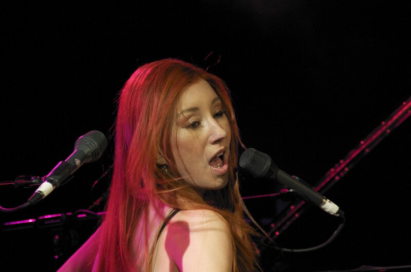 woman singing on stage