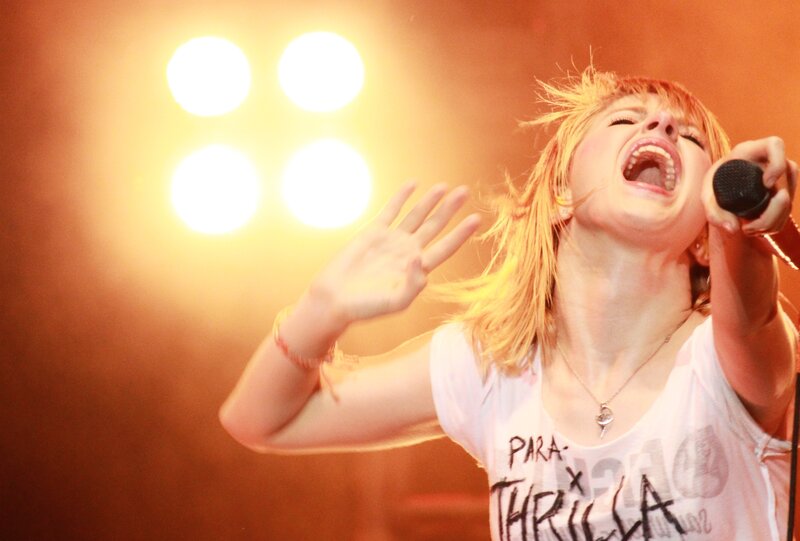 woman singing on stage