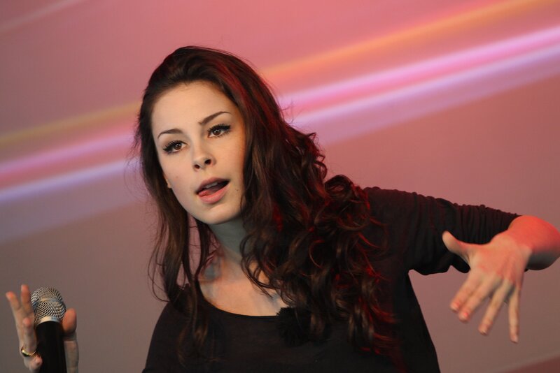 woman singing on stage