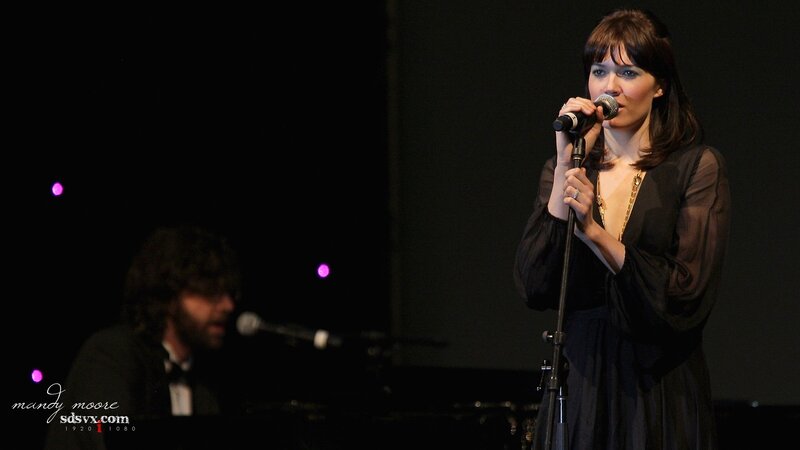 woman singing on stage