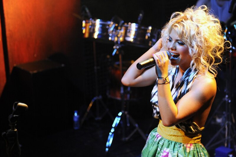 woman singing on stage