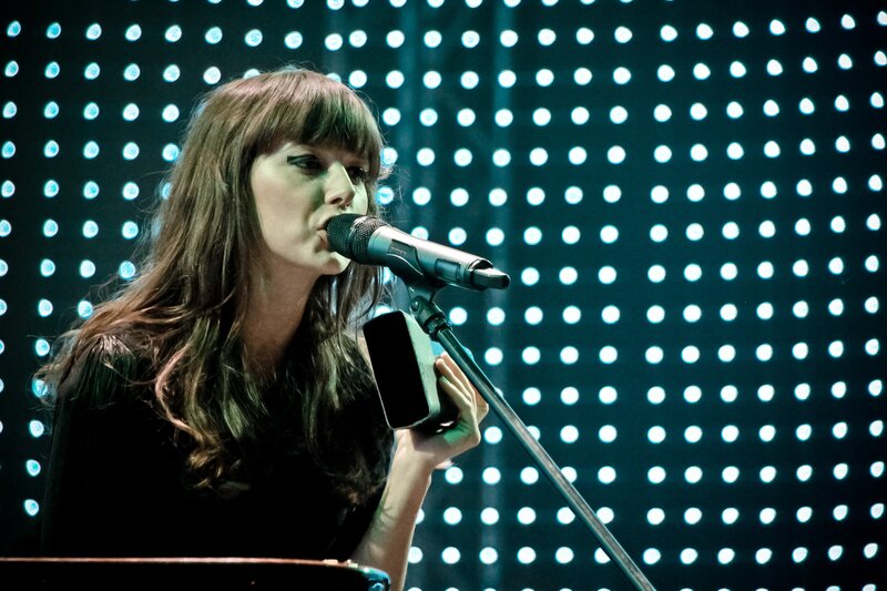 woman singing on stage