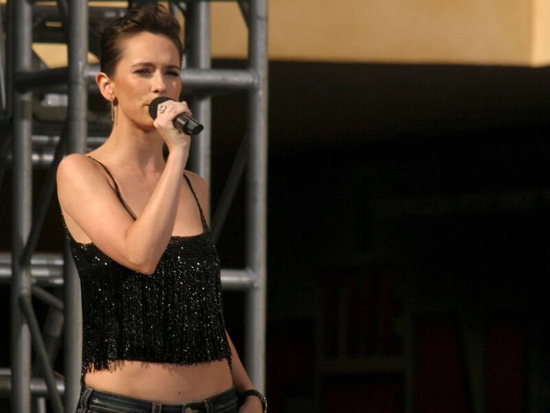woman singing on stage