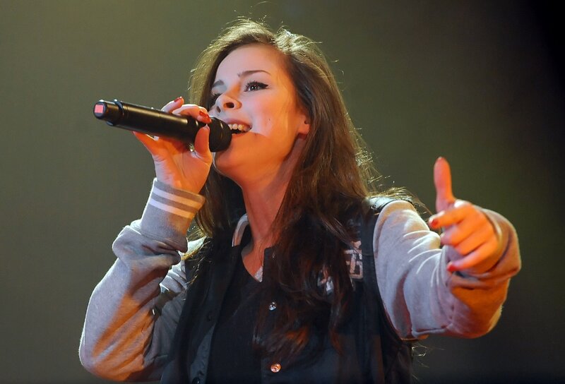 woman singing on stage