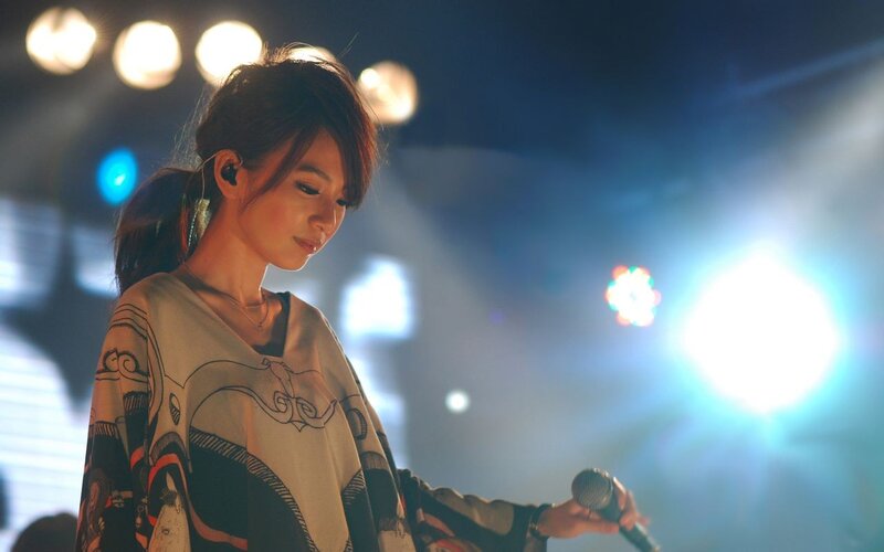 woman singing on stage