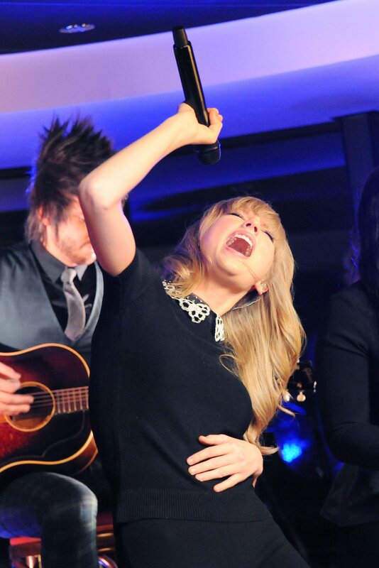 woman singing on stage