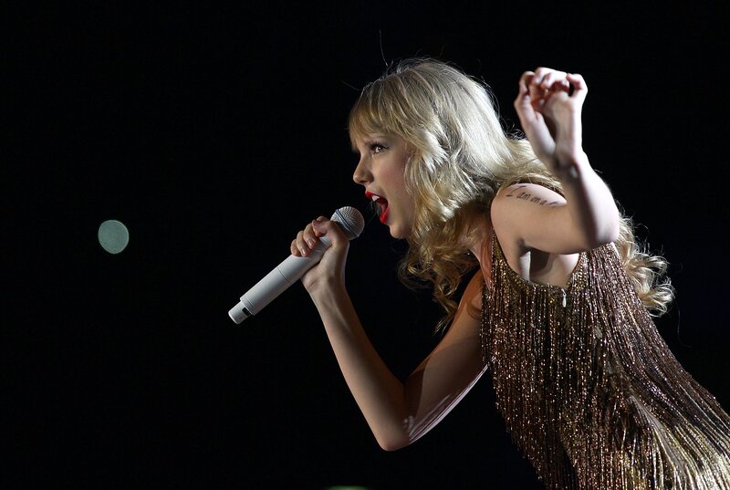 woman singing on stage