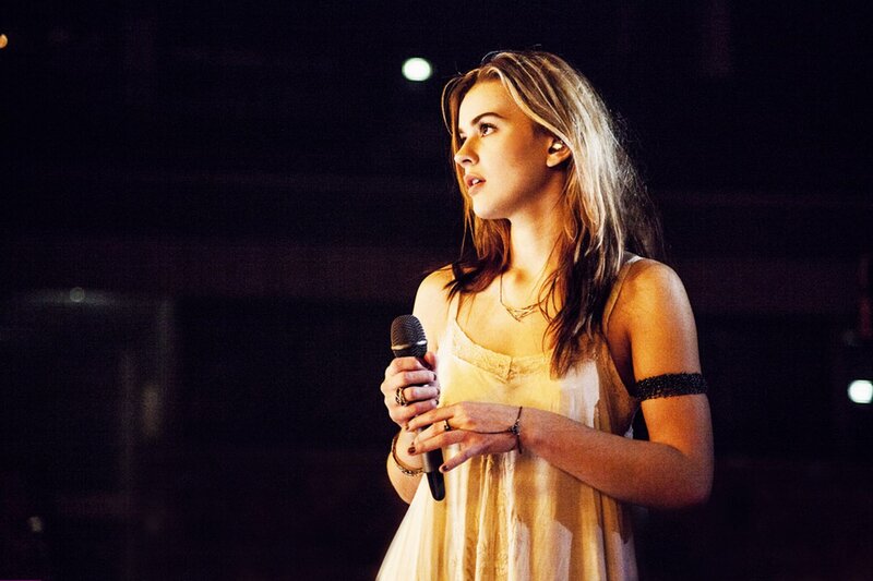 woman singing on stage