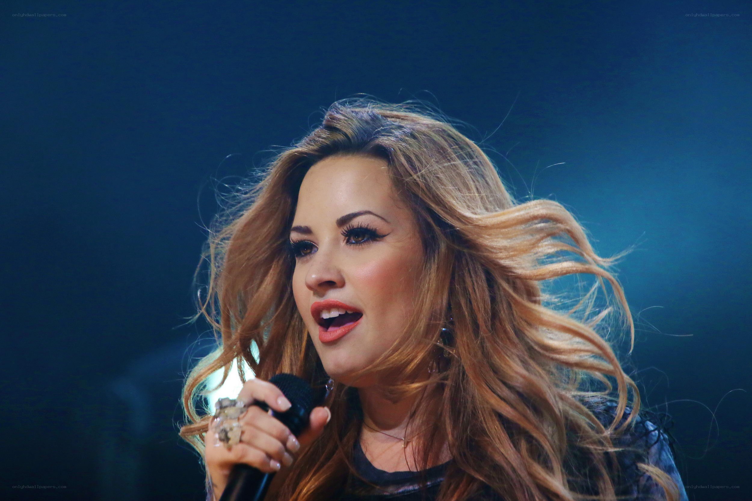 woman singing on stage