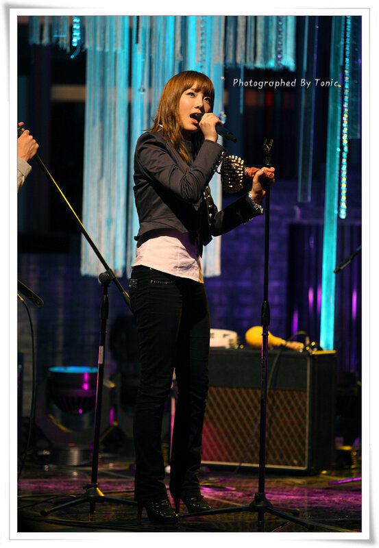 woman singing on stage
