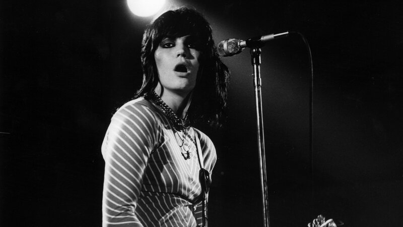 Woman Singing on Stage — Black, Dramatic, Night, Photograph, Microphone, Stage Light, Necklace