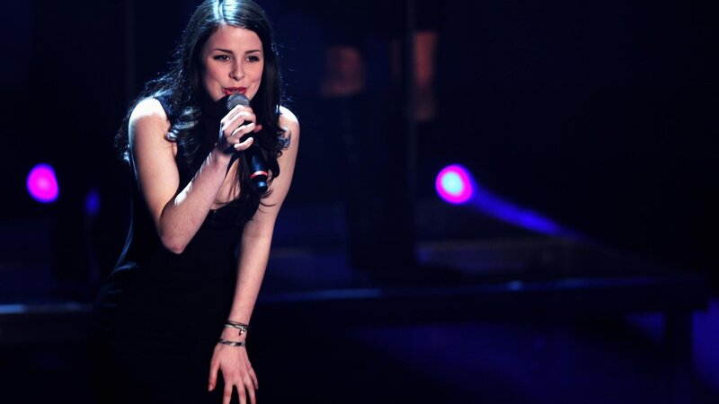 Woman Singing on Stage — Black, Dramatic, Night, Photograph, Microphone, Stage Lights, Bracelet