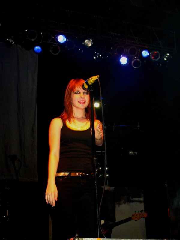 Woman Singing on Stage — Black, Dramatic, Night, Photograph, Microphone, Stage Lights, Guitar, Red