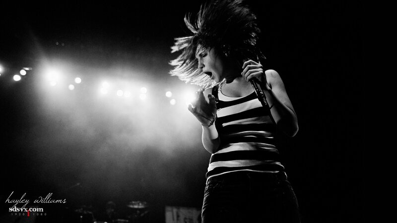 Woman Singing on Stage — Black, Dramatic, Night, Photograph, Microphone, Stage Lights, Smoke, White