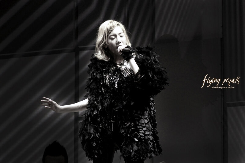 Woman Singing on Stage — Black, Dramatic, Photograph, Microphone, Stage Lights