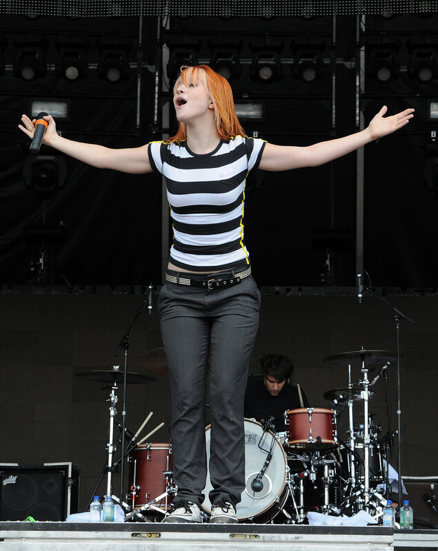 Woman Singing on Stage — Black, Energetic, Afternoon, Photograph, Drum Set