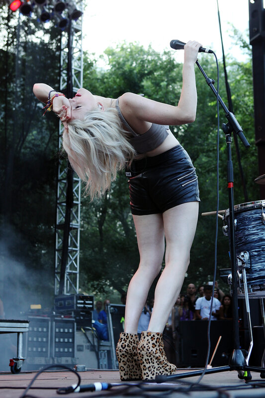 Woman Singing on Stage — Black, Energetic, Afternoon, Photograph, Microphone, Drum Kit, White