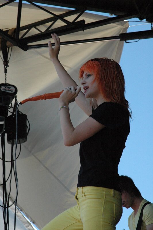 Woman Singing on Stage — Black, Energetic, Afternoon, Photograph, Microphone, Person