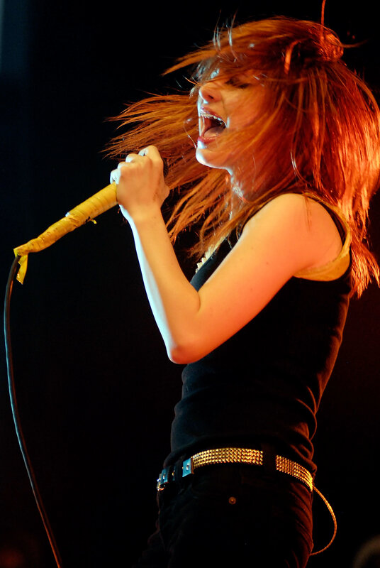 Woman Singing on Stage — Black, Energetic, Night, Photograph, Microphone, Stage Light, Belt