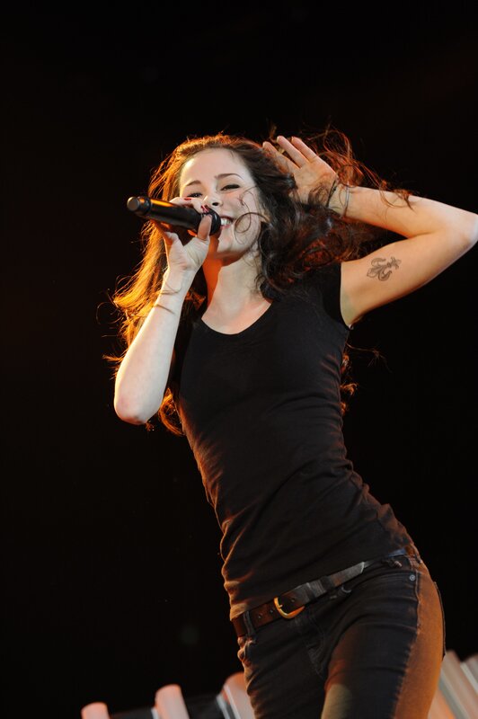 Woman Singing on Stage — Black, Energetic, Night, Photograph, Microphone, Tattoo