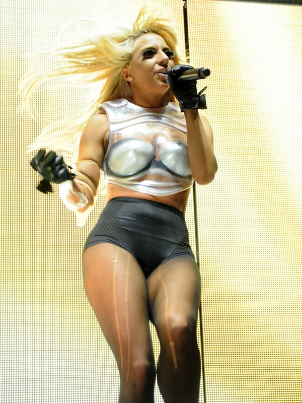 Woman Singing on Stage — Black, Energetic, Photograph, Microphone, Gloves