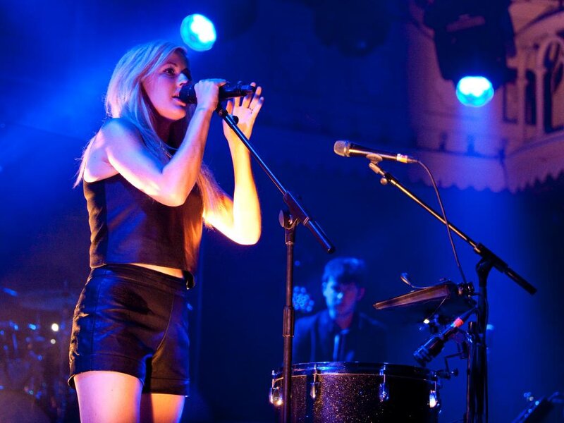 Woman Singing on Stage — Blue, Dramatic, Night, Photograph, Microphone, Drum Kit