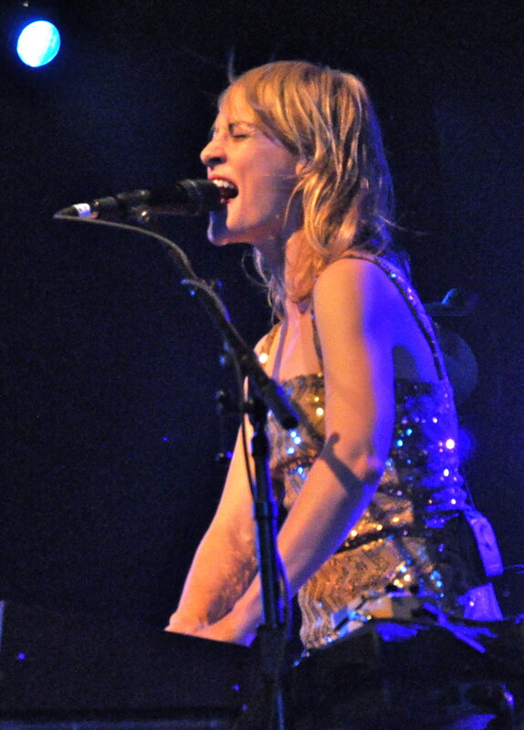 Woman Singing on Stage — Blue, Dramatic, Night, Photograph, Microphone, Stage Light, Sequined Dress