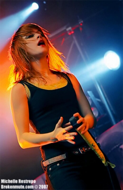 Woman Singing on Stage — Blue, Dramatic, Night, Photograph, Microphone, Stage Lights, Jeans