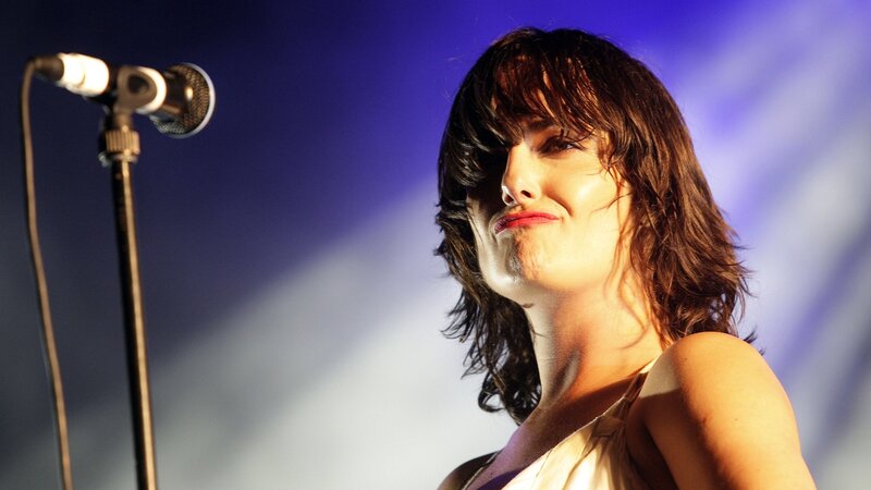 Woman Singing on Stage — Blue, Dramatic, Photograph, Microphone, Stage Light