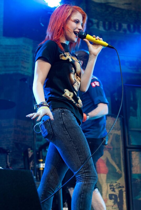 Woman Singing on Stage — Blue, Energetic, Night, Photograph, Microphone, Jeans