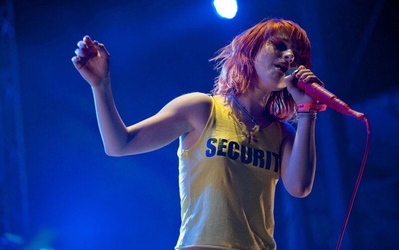 Woman Singing on Stage — Blue, Energetic, Night, Photograph, Microphone, Stage Light