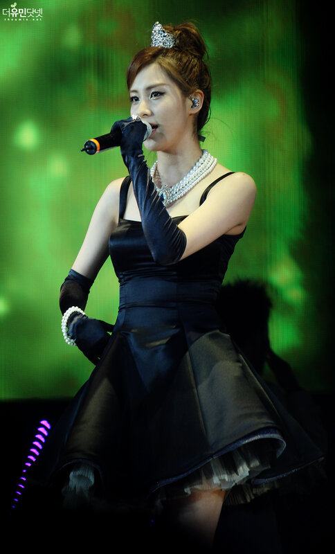 woman singing on stage in black dress