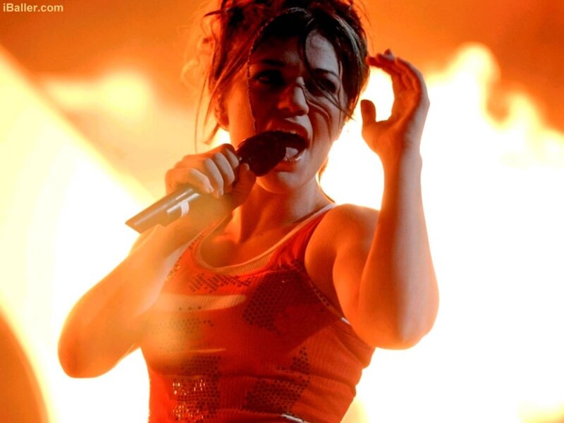 Woman Singing on Stage — Orange, Dramatic, Photograph